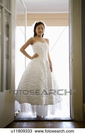 Portrait of an Asian bride standing in doorway. View Large Photo Image Stock Image - Portrait of an Asian bride standing in doorway.. Fotosearch