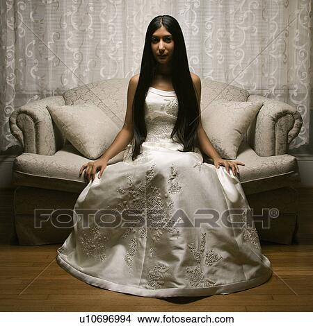 Portrait of an Indian bride sitting on a love seat. View Large Photo Image Picture - Portrait of an Indian bride sitting on a love seat.. Fotosearch