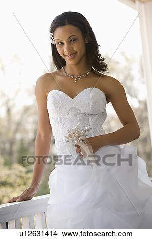 Portrait of bride leaning against railing View Large Photo Image Picture - Portrait of bride leaning against railing. Fotosearch
