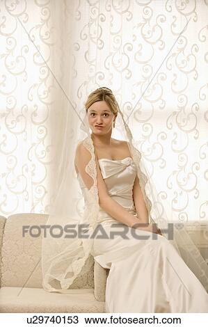 Portrait of Caucasian bride sitting on love seat making a funny expression. View Large Photo Image Stock Image - Portrait of Caucasian bride sitting on love seat making a funny expression.. Fotosearch