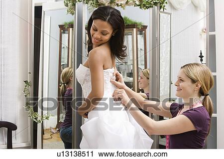 Seamstress helping bride in bridal shop. View Large Photo Image Stock Image - Seamstress helping bride in bridal shop.. Fotosearch