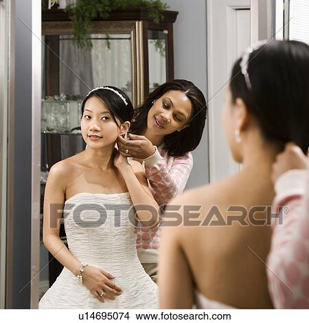 Woman helping bride with hair View Large Photo Image Picture - Woman helping bride with hair. Fotosearch