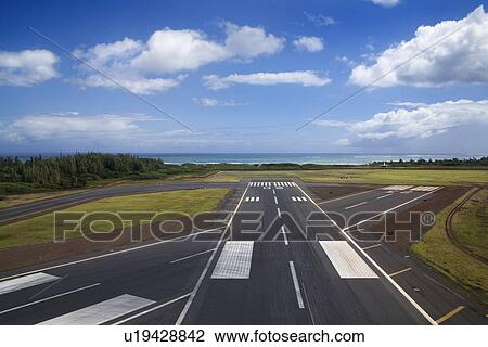 Stock Image - Aerial view of airport runway on coastline of Maui, Hawaii. Fotosearch