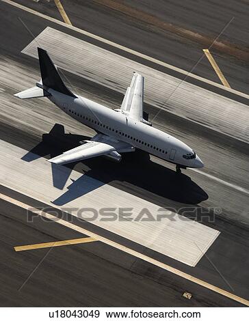 Aerial view of passenger airplane on airport runway View Large Photo Image Stock Photo - Aerial view of passenger airplane on airport runway. Fotosearch