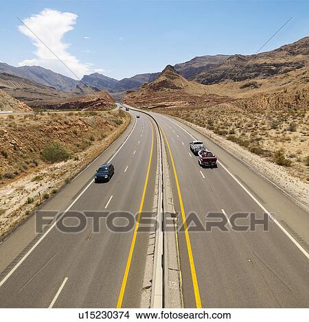 Picture - Birds eye view of automobiles on rural desert highway. Fotosearch