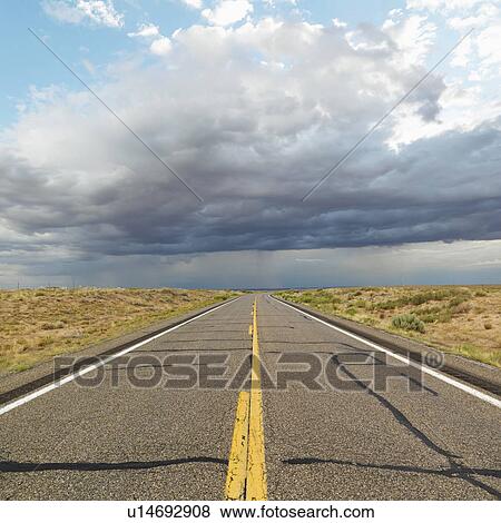 Empty two lane highway leading to desert horizon View Large Photo Image Stock Photo - Empty two lane highway leading to desert horizon. Fotosearch
