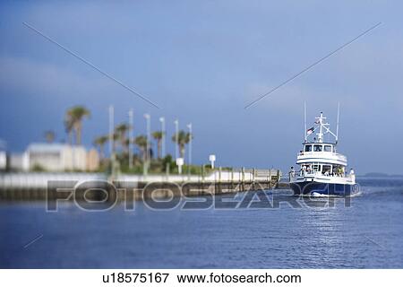 Ferry boat heading into port on Bald Head Island, North Carolina. View Large Photo Image Stock Photo - Ferry boat heading into port on Bald Head Island, North Carolina.. Fotosearch