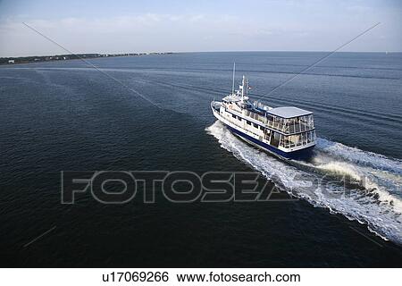 Ferry boat transporting passengers across Atlantic Ocean near Bald Head Island, North Carolina. View Large Photo Image Stock Photograph - Ferry boat transporting passengers across Atlantic Ocean near Bald Head Island, North Carolina.. Fotosearch