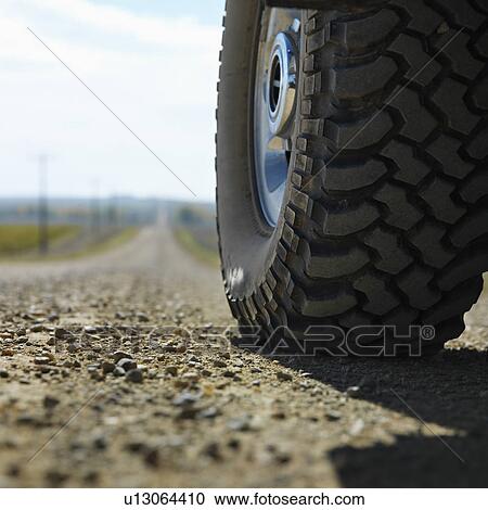 Low angle view of big truck tire on gravel road in rural South Dakota. View Large Photo Image Stock Image - Low angle view of big truck tire on gravel road in rural South Dakota.. Fotosearch