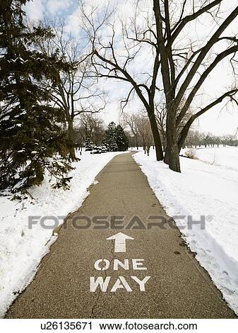 Stock Image - Paved path in park reading one way.. Fotosearch