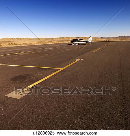 Plane in distance parked on tarmac at Canyonlands Field Airport, Utah, United States. View Large Photo Image Stock Photography - Plane in distance parked on tarmac at Canyonlands Field Airport, Utah, United States.. Fotosearch
