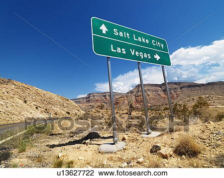 Stock Image - Road sign in desert pointing towards Salt Lake City and Las Vegas. Fotosearch