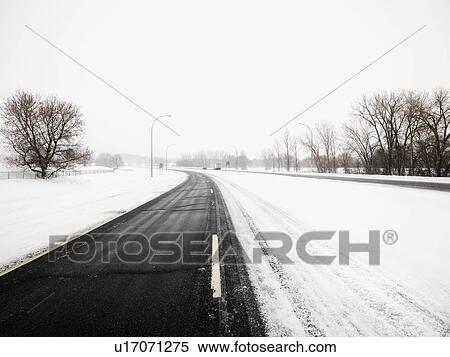 Snow covered road in Midwestern View Large Photo Image Stock Photography - Snow covered road in Midwestern. Fotosearch