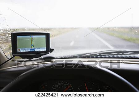 Vehicle dashboard with GPS and view through windshield of highway ahead. View Large Photo Image Stock Image - Vehicle dashboard with GPS and view through windshield of highway ahead.. Fotosearch