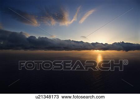 Aerial of sun setting over Pacific ocean with clouds View Large Photo Image Stock Image - Aerial of sun setting over Pacific ocean with clouds. Fotosearch