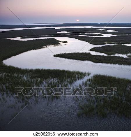 Aerial scenic view of winding waterway in marshland at Baldhead Island, North Carolina. View Large Photo Image Stock Photograph - Aerial scenic view of winding waterway in marshland at Baldhead Island, North Carolina.. Fotosearch