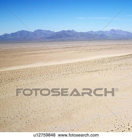 Stock Photo - Aerial view of remote California desert with mountain range in background. Fotosearch