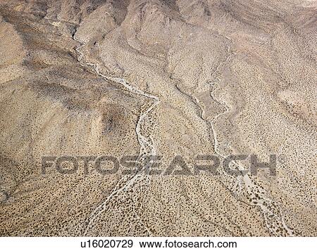 Aerial view of torrid California desert with rocky landforms View Large Photo Image Stock Photo - Aerial view of torrid California desert with rocky landforms. Fotosearch
