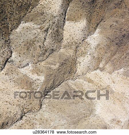 Stock Photo - Aerial view of torrid California desert with rocky landforms.. Fotosearch