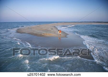 Birds eye view of couple on sandbar at Bald Head Island, North Carolina during sunrise View Large Photo Image Stock Image - Birds eye view of couple on sandbar at Bald Head Island, North Carolina during sunrise. Fotosearch