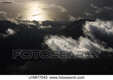 Mountains with clouds by Pacific ocean on Maui, Hawaii View Large Photo Image Stock Image - Mountains with clouds by Pacific ocean on Maui, Hawaii. Fotosearch