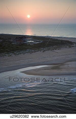 Stock Image - Scenic aerial view of Baldhead Island, North Carolina beach at dusk.. Fotosearch