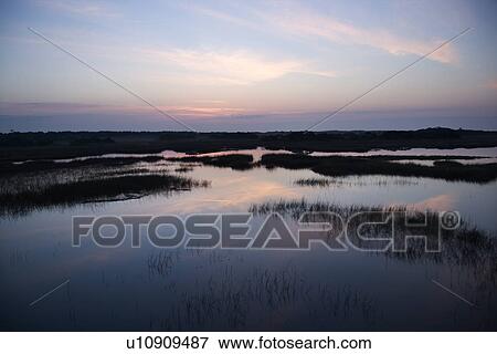 Stock Photo - Sky reflecting water in marsh area on Bald Head Island, North Carolina. Fotosearch