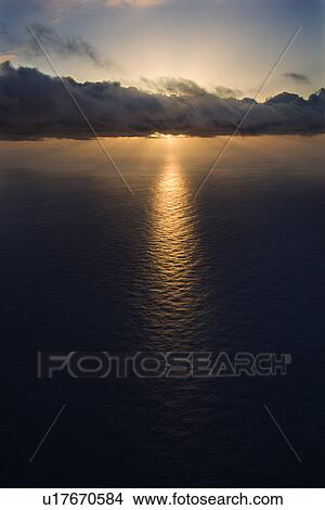 Sun setting over Pacific ocean with clouds View Large Photo Image Picture - Sun setting over Pacific ocean with clouds. Fotosearch