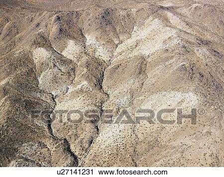 Stock Image - Torrid California desert with rocky landforms. Fotosearch