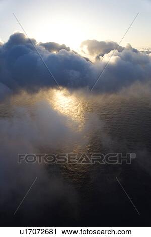 View from above the clouds with Pacific ocean below View Large Photo Image Stock Image - View from above the clouds with Pacific ocean below. Fotosearch