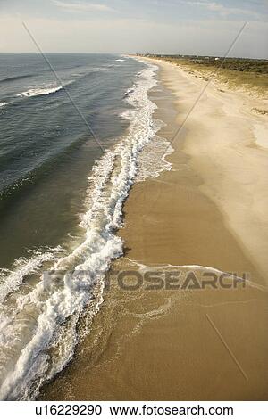Waves crashing on beach on Bald Head Island, North Carolina View Large Photo Image Stock Image - Waves crashing on beach on Bald Head Island, North Carolina. Fotosearch