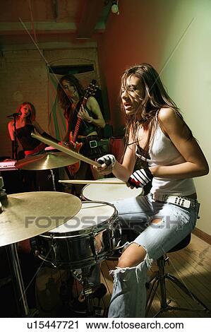 Stock Image - Caucasian girl band playing instruments.. Fotosearch