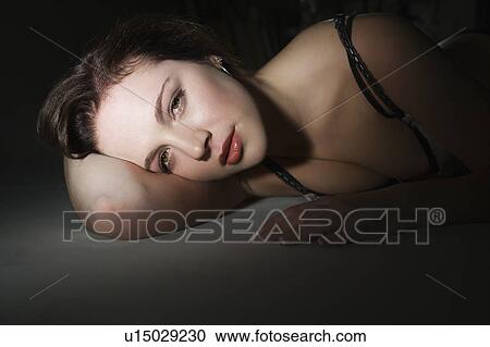 Sexy Caucasian woman in bra lying on floor looking at viewer. View Large Photo Image Stock Image - Sexy Caucasian woman in bra lying on floor looking at viewer.. Fotosearch