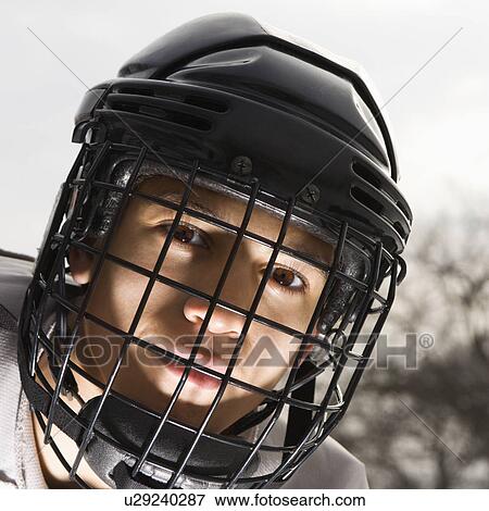 Boy in ice hockey uniform making eye contact View Large Photo Image Stock Photo - Boy in ice hockey uniform making eye contact. Fotosearch