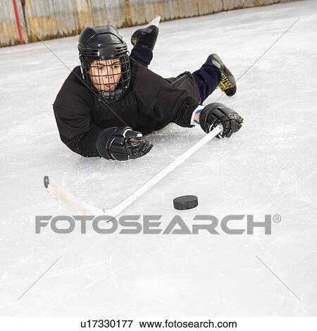 Boy playing ice hockey View Large Photo Image Stock Photo - Boy playing ice hockey. Fotosearch