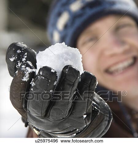 Caucasian male teenager holding snowball out towards viewer. View Large Photo Image Stock Photograph - Caucasian male teenager holding snowball out towards viewer.. Fotosearch