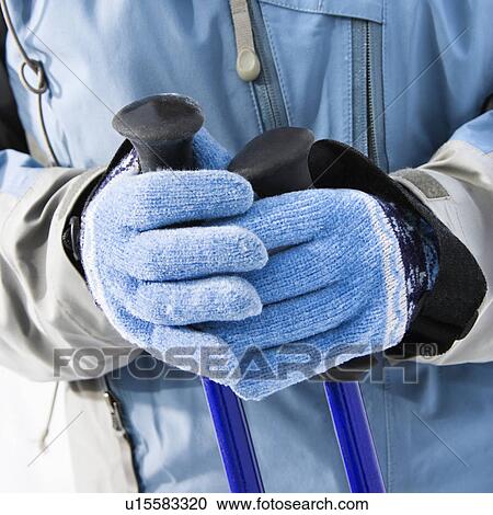 Close up of female skier hands wearing blue gloves holding ski poles. View Large Photo Image Stock Image - Close up of female skier hands wearing blue gloves holding ski poles.. Fotosearch