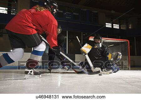 Female hockey player trying to make goal as goalie protects the net. View Large Photo Image Stock Image - Female hockey player trying to make goal as goalie protects the net.. Fotosearch
