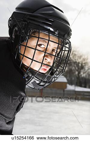 Boy In Hockey Mask With Serious Expression Hockey Player Boy In And Cage Helmet