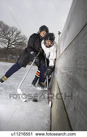 Ice hockey player boy slamming other player into wall trying to get to puck View Large Photo Image Stock Image - Ice hockey player boy slamming other player into wall trying to get to puck. Fotosearch