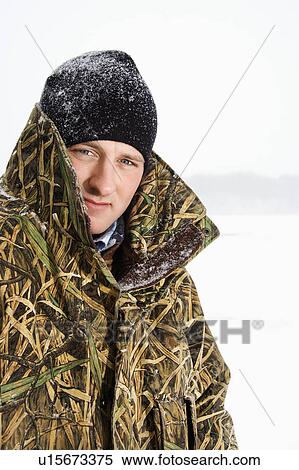 Male wearing camouflage jacket and beanie on frozen Green Lake, Minnesota View Large Photo Image Stock Photography - Male wearing camouflage jacket and beanie on frozen Green Lake, Minnesota. Fotosearch