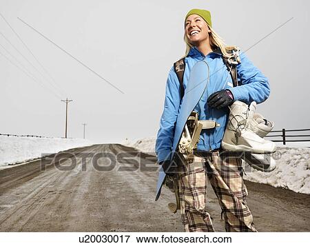 Stock Photo - Woman standing on muddy dirt road . Fotosearch