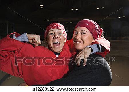 Women hockey players excited and posing with helmets off on ice rink View Large Photo Image Stock Image - Women hockey players excited and posing with helmets off on ice rink. Fotosearch