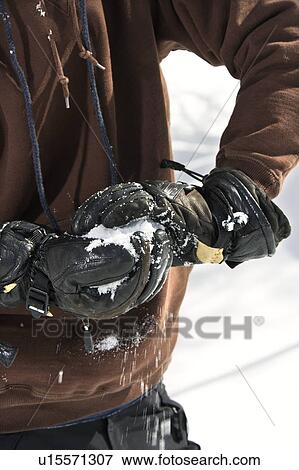 Stock Photo - Gloved hands making snowball. Fotosearch