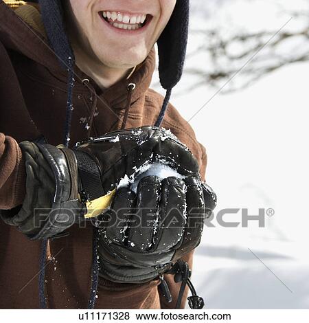 Male teenager making snowball in winter View Large Photo Image Stock Photo - Male teenager making snowball in winter . Fotosearch