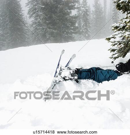 Stock Photo - Skiers lying after crash in fog. Fotosearch