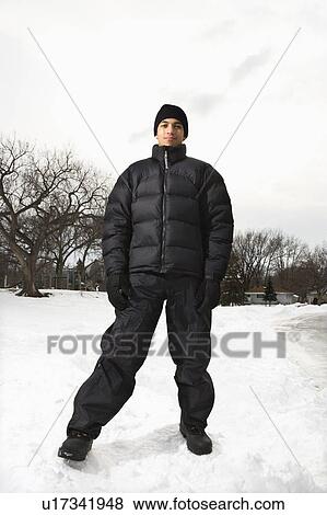 Teenage boy standing in snow wearing winter clothes. View Large Photo Image Stock Photo - Teenage boy standing in snow wearing winter clothes.. Fotosearch