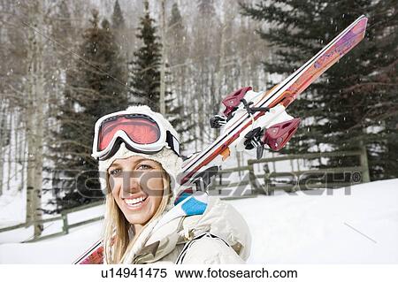 Woman carrying skis View Large Photo Image Stock Photography - Woman carrying skis . Fotosearch