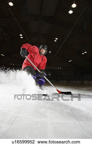 Woman hockey player sliding kicking up ice View Large Photo Image Stock Image - Woman hockey player sliding kicking up ice. Fotosearch