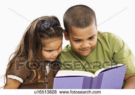 Stock Photo - Boy and girl reading book together.. Fotosearch
